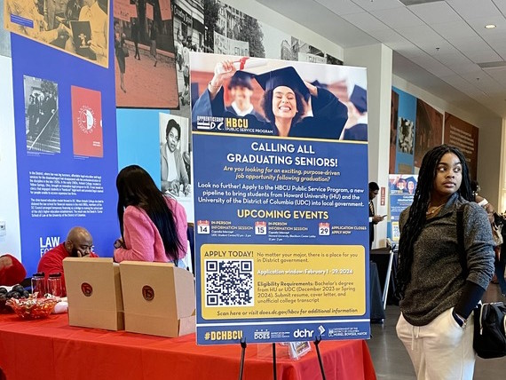UDC student next to a sign promoting the HBCU program